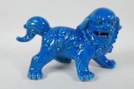 A Chinese turquoise glazed porcelain temple lion, 26cm long