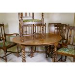 An early C20th oak wind out dining table, with extra leaf, raised on handed barley twist supports,