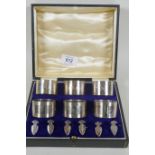 A cased set of six hallmarked napkin rings and markers, Birmingham 1925, Docker & Burn, 240g