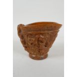 A Chinese faux horn libation cup with carved kylin decoration, seal mark to base, 10cm high