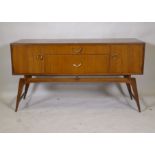 A mid century teak dressing table/low side cabinet, with two cupboards flanking two drawers,