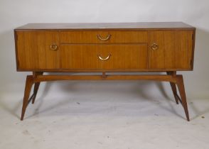 A mid century teak dressing table/low side cabinet, with two cupboards flanking two drawers,
