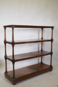 A C19th rosewood four tier buffet, raised on turned tapering columns, good faded colour, and a