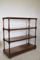A C19th rosewood four tier buffet, raised on turned tapering columns, good faded colour, and a