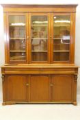 A C19th French stained fruitwood and walnut bookcase, the upper section with two glazed doors,