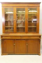 A C19th French stained fruitwood and walnut bookcase, the upper section with two glazed doors,