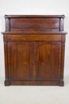 A Regency rosewood chiffonier, the upper shelf with three quarter gallery over a single frieze