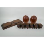 An antique Black Forest carved wood pipe rack with bear's head decoration, a pair of turned wood