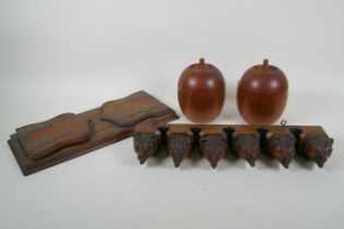 An antique Black Forest carved wood pipe rack with bear's head decoration, a pair of turned wood