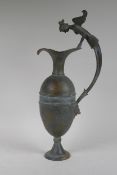 A Greco-Roman style bronze urn, the handle decorated with the bust of a siren, 48cm high