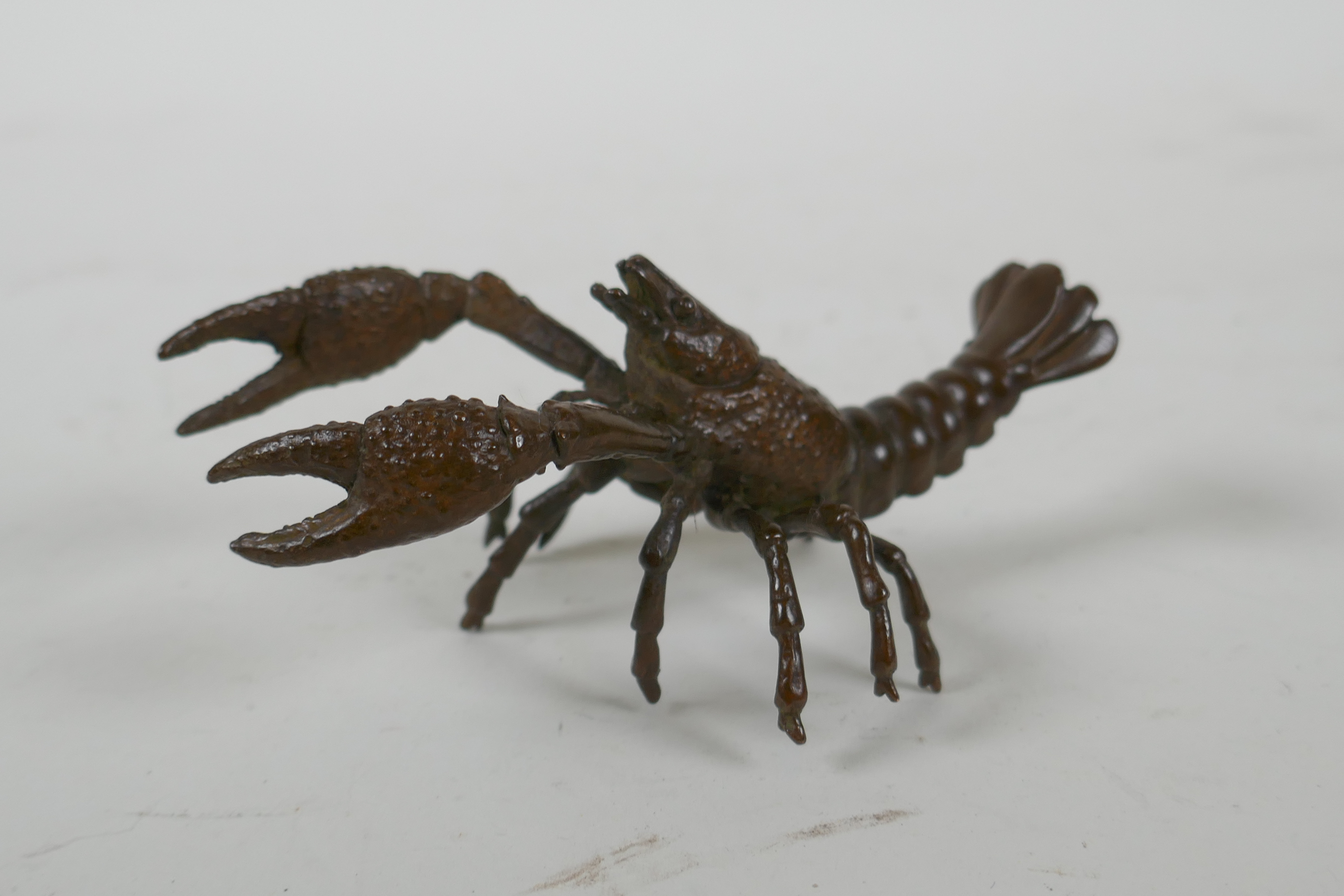 A Japanese style bronze okimono crayfish, 10cm long