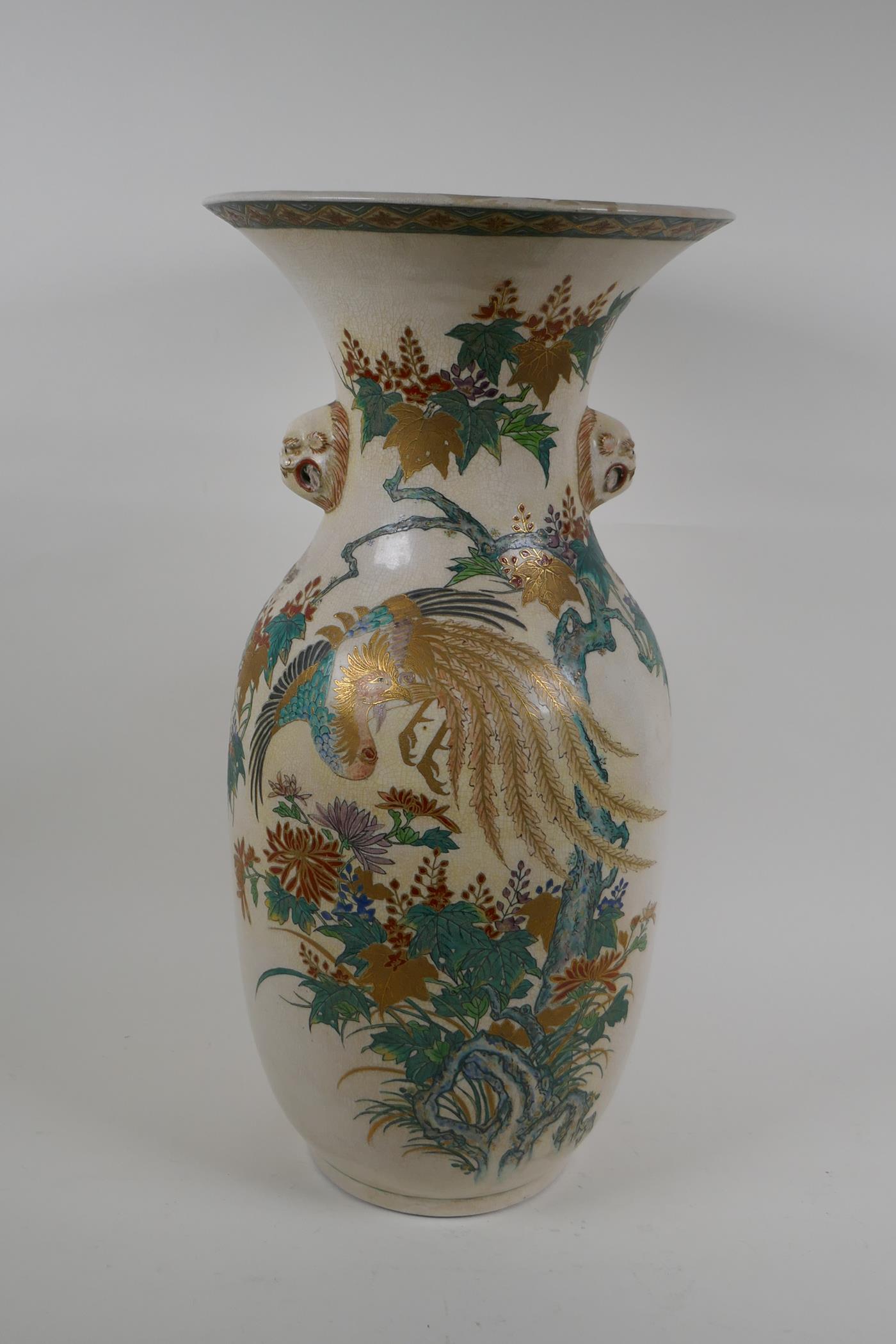A Japanese Meiji Satsuma vase, with twin mask handles, decorated with a phoenix in flight, 48cm high