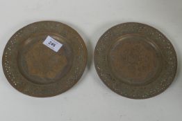 A pair of Indian/Persian brass dishes with pierced rims and engraved decoration of men feasting