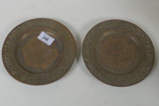 A pair of Indian/Persian brass dishes with pierced rims and engraved decoration of men feasting