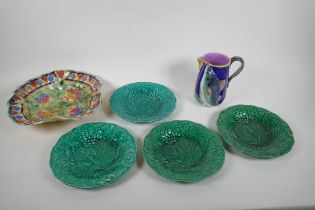 A Victorian Majolica jug with salmon decoration, four Majolica vine leaf plates, and a Beswick