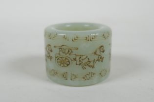 A Chinese mottled celadon jade archers thumb ring, with horse and cart decoration, 2cm diameter