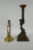 An antique brass candle stick with putto decoration, together with an Art Nouveau style bronzed cast