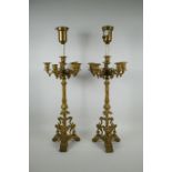 A pair of French ormolu five branch candlesticks on a tripod base with griffin decoration, the