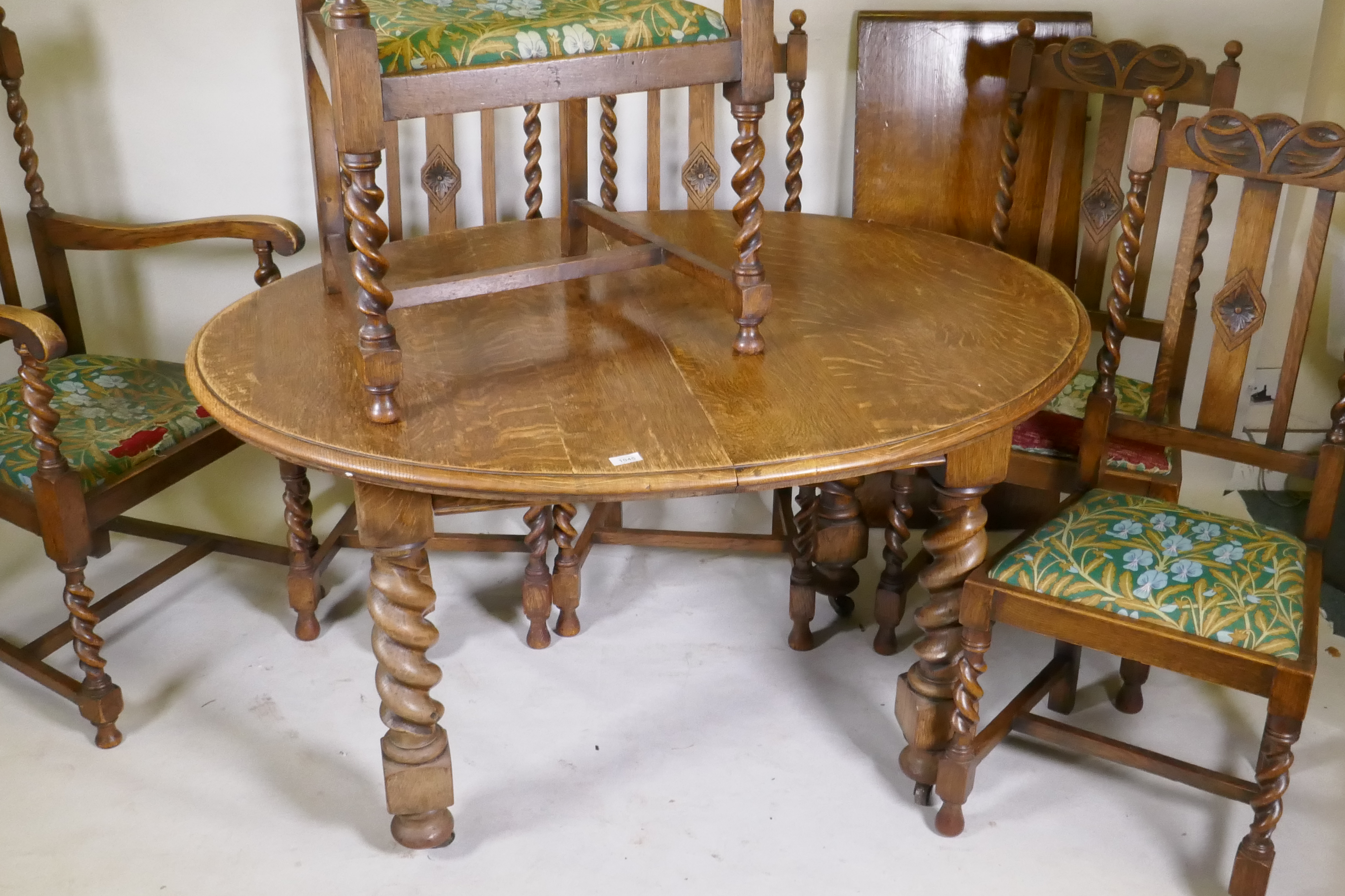An early C20th oak wind out dining table, with extra leaf, raised on handed barley twist supports, - Image 2 of 7