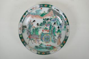 A Chinese KangXi style famille vert porcelain charger decorated with female travellers and deer