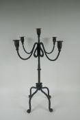 A painted wrought metal four branch candelabra, 59cm high