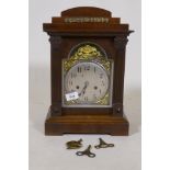 A C19th oak cased Black Forest mantel clock with silvered dial and pierced brass spandrels and