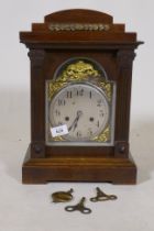 A C19th oak cased Black Forest mantel clock with silvered dial and pierced brass spandrels and