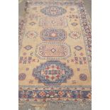 A wool carpet with oriental style design, frayed and worn, 270 x 180cm