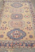 A wool carpet with oriental style design, frayed and worn, 270 x 180cm