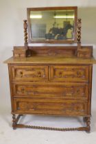 An early C20th oak Jacobean style dressing table, with swing mirror supported by barley twist
