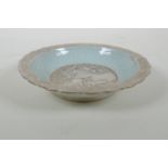 A Chinese celadon ground porcelain dish with lobed rim, and silver glazed details, decorated with