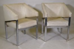 A pair of chrome metal framed arm chairs with vinyl covers