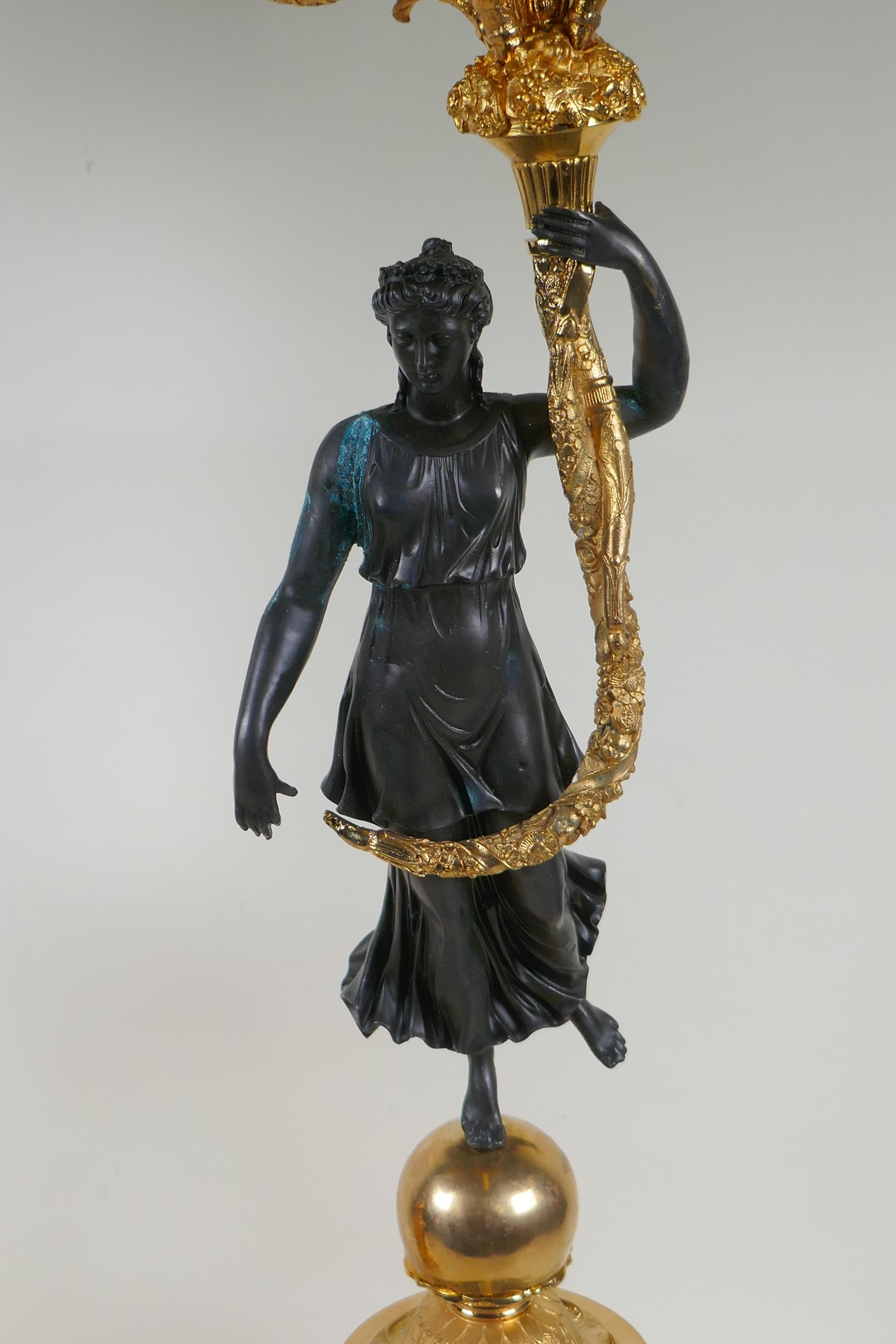 A pair of Regency style bronze and ormolu four branch candelabra in the form of classical women - Image 6 of 6