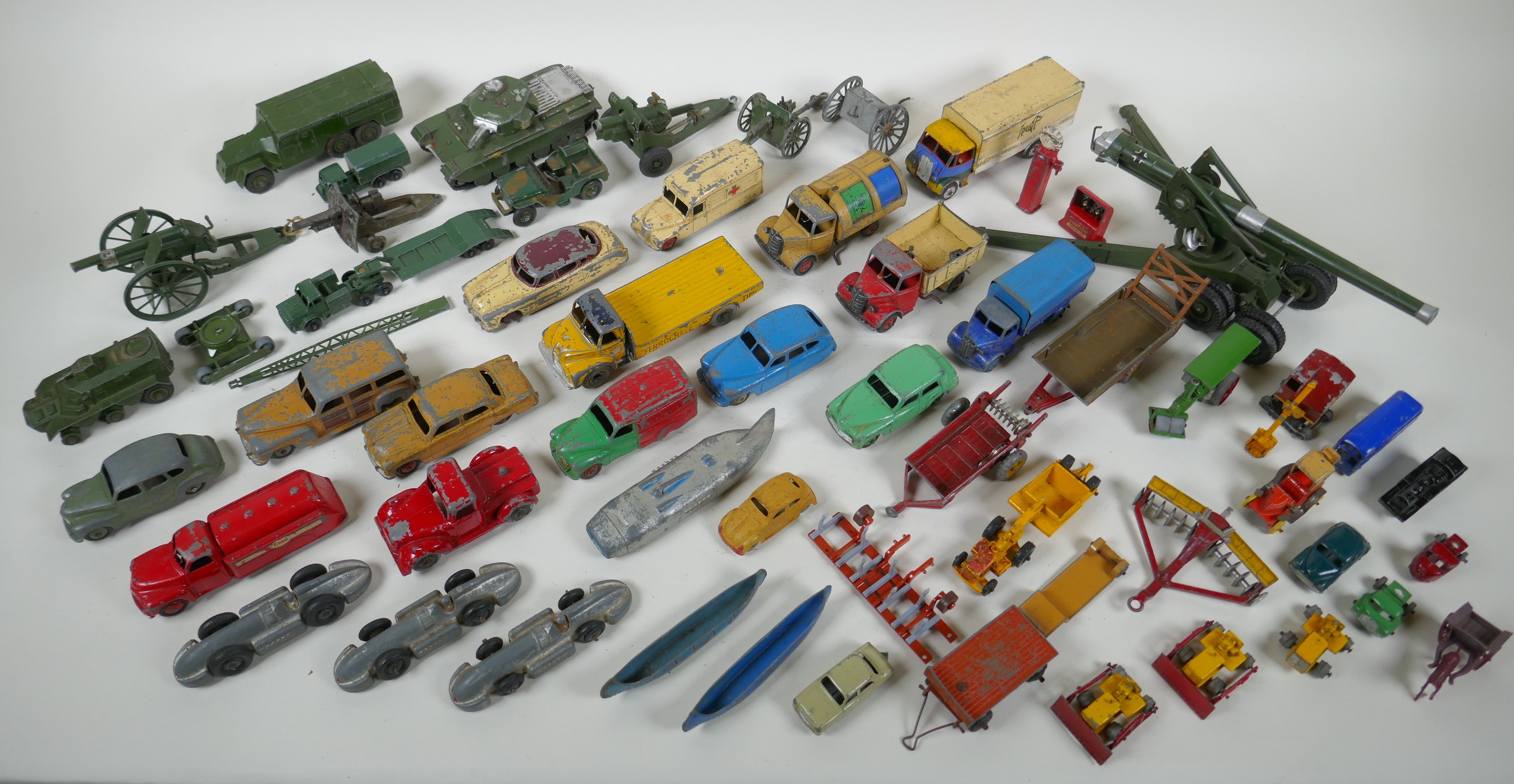A collection of vintage die cast metal cars, trucks, military vehicles and farming vehicles,