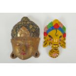 An Indian carved and painted wood Ganesh wall mask and another carved and gilt Buddha mask,