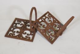 A pair of cast iron wall brackets with fold down pot holders, 19 x 19 x 19cm