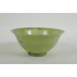 A Chinese marbled green jade rice bowl, 13cm diameter