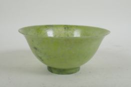 A Chinese marbled green jade rice bowl, 13cm diameter