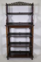 William IV? rosewood six tier etagere, with pierced and carved galleries, the shelves united by