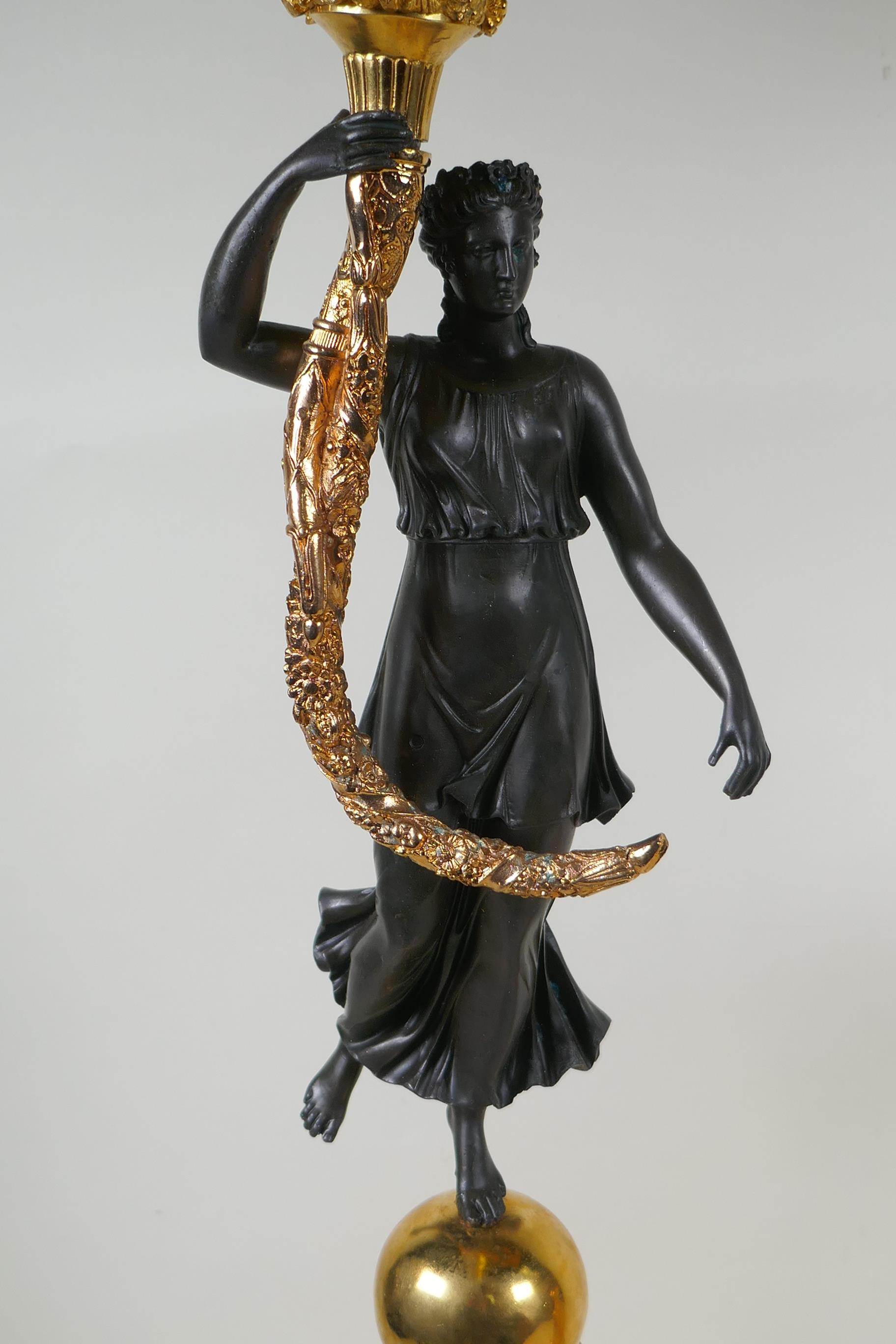 A pair of Regency style bronze and ormolu four branch candelabra in the form of classical women - Image 3 of 6