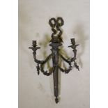 An Empire style three branch wall sconce in the form of an arrow quiver, with ribbons and floral