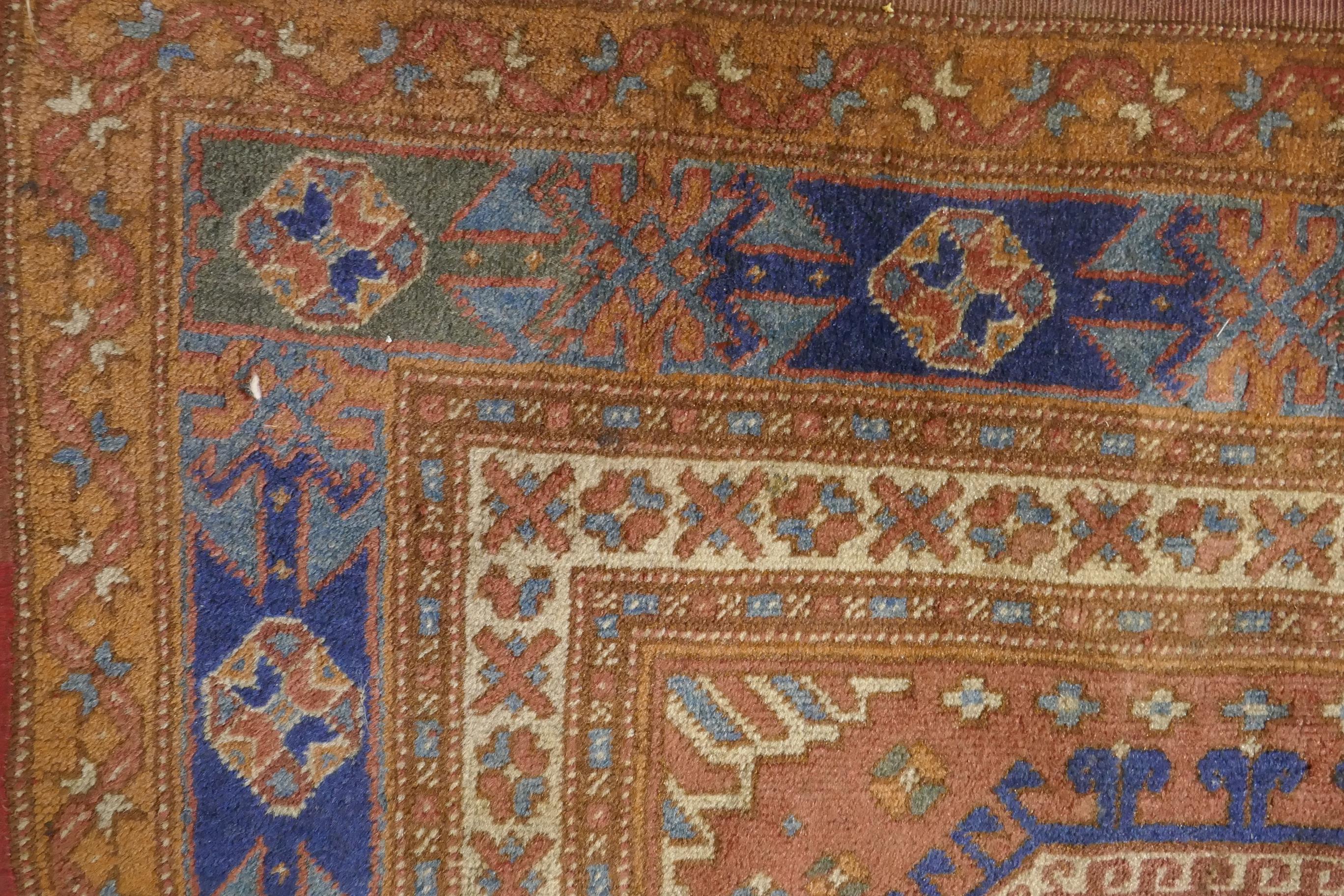 An antique Bergama carpet, with geometric designs on a terracotta coloured field and soft sheen to - Image 5 of 6