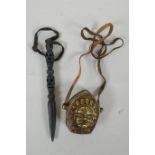 A Tibetan cast metal phurba with skull shaped decoration to handle, together with a brass and copper