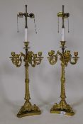 A pair of ormolu five branch candelabra table lamps with twisted columns and scroll supports, 84cm