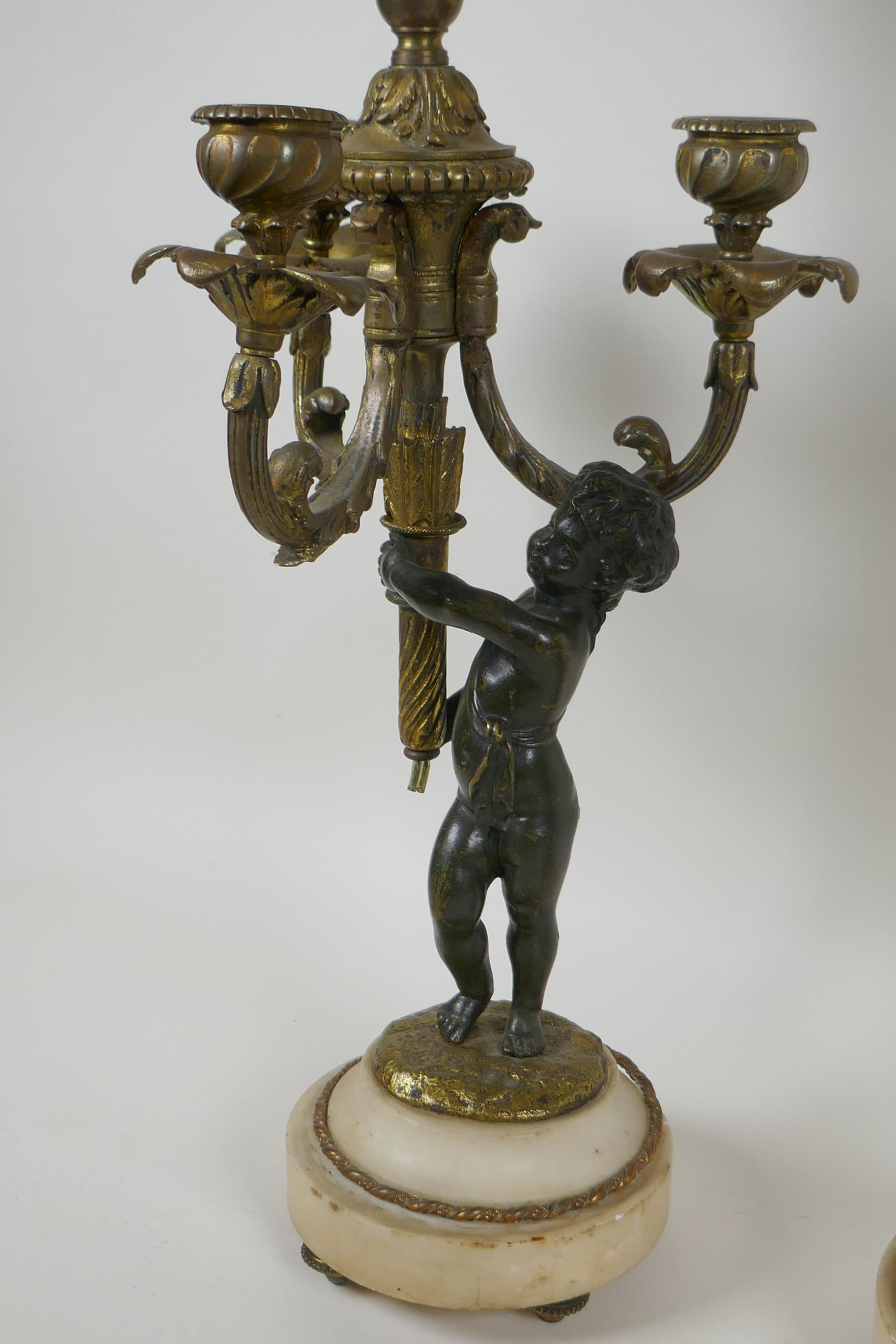 A pair of bronze and ormolu cherub three branch candlesticks converted to a lamp, 60cm high - Image 4 of 4