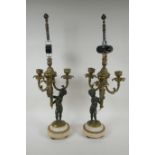 A pair of bronze and ormolu cherub three branch candlesticks converted to a lamp, 60cm high