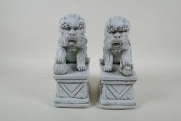 A pair of Chinese blanc de chine porcelain temple lions, impressed marks to the reverse, 24cm high