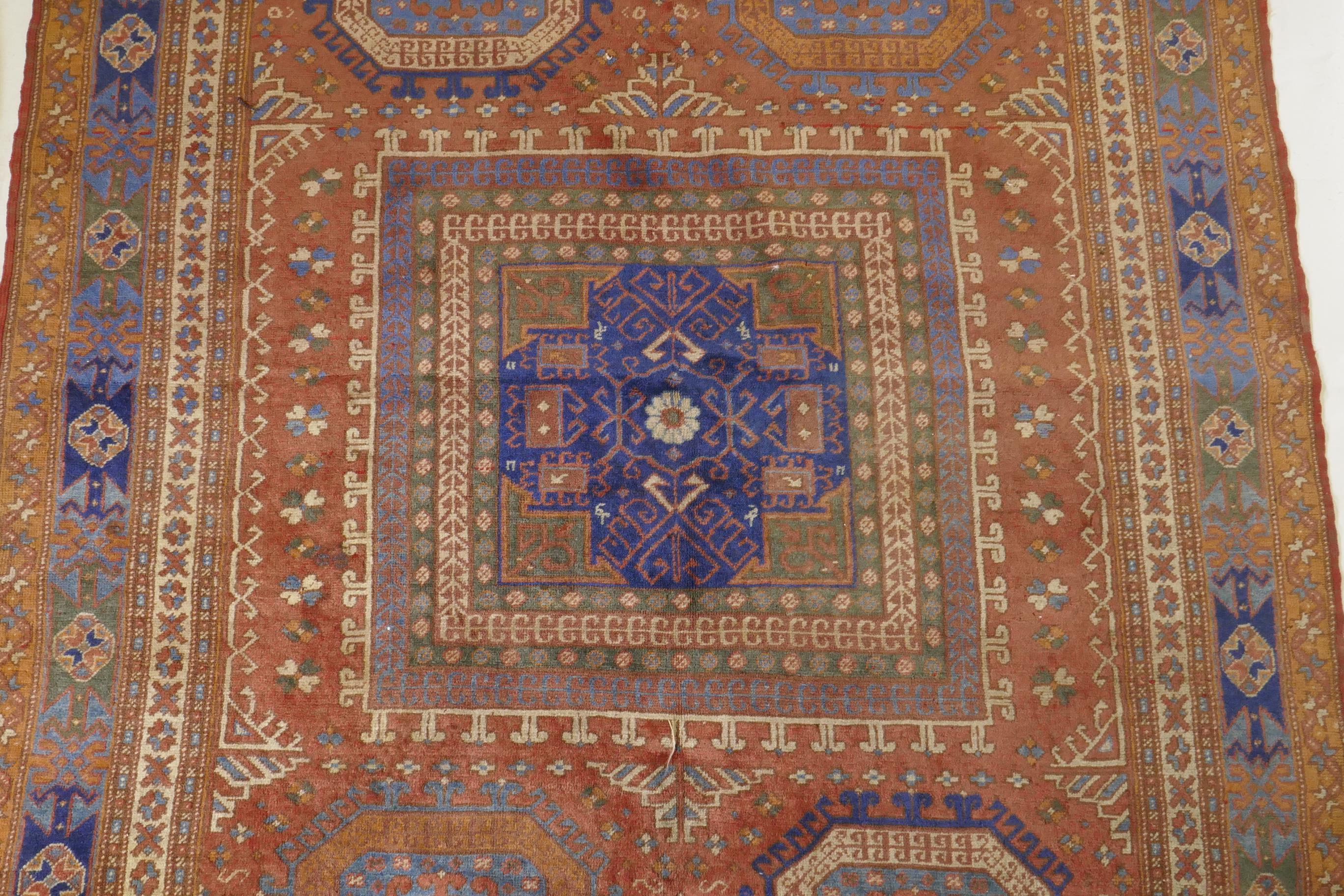 An antique Bergama carpet, with geometric designs on a terracotta coloured field and soft sheen to - Image 3 of 6
