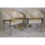 A pair of chrome metal framed arm chairs with vinyl covers