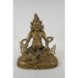 A Tibetan bronze figure of Jambhala, double vajra mark to base, 29cm high
